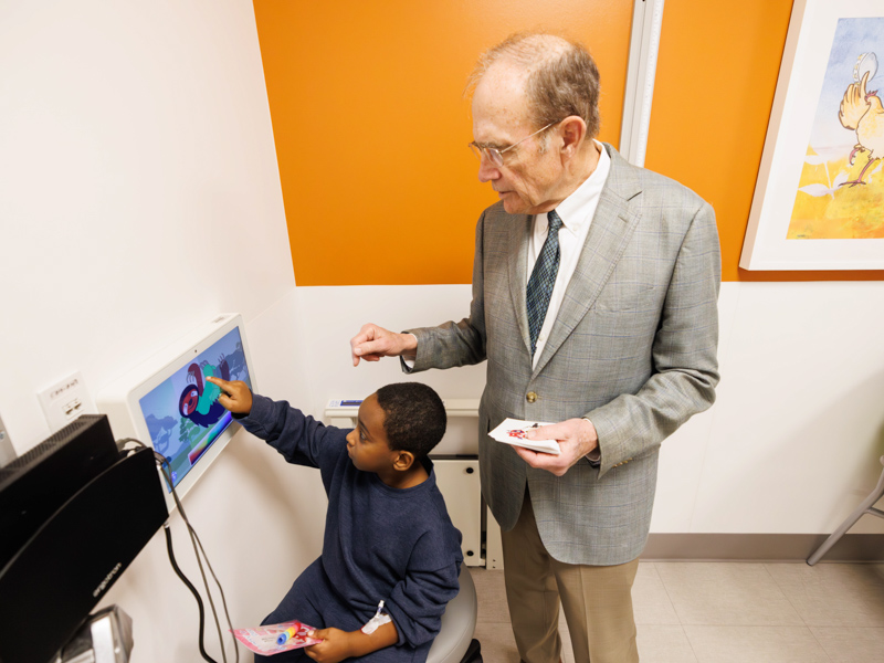 Tre'veon Farley, 6, of Maben draws with Lt Governor Delbert Hosemann. Melanie Thortis/ UMMC Communications