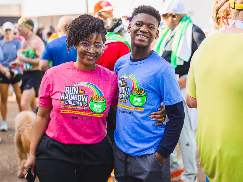 Elizabeth Foster and son Kingston Frazier, former Children's Champion, show off their 2026 Run the Rainbow gear at the 2026 Run the Rainbow race benefitting Children's of Mississippi.