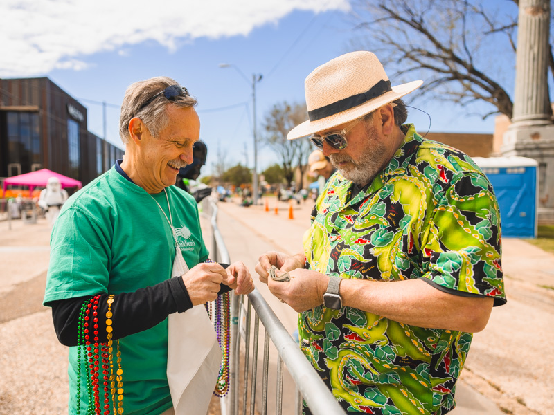Brad Ewing, director-development schools at UMMC, collects a donation from Charles Lewis at City Sweep benefitting the children's hospital. Lindsay McMurtray/ UMMC Communications