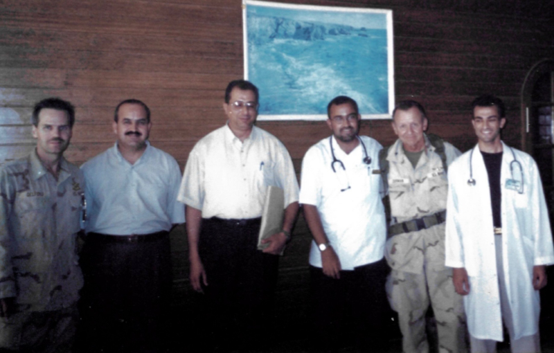 Physicians, including Dr. Alshibli, far right, from Iraq and the U.S. gather at Al-Diwaniyah General Hospital, about 120 miles south of Baghdad, after reaching an agreement to share hospital resources and collaborate in treating wounded patients during the Iraq War.