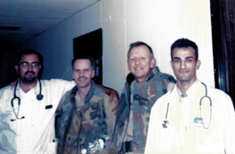 Dr. Alshibli, far right, stands with medical colleagues during the Iraq War. Emergency medicine physician Brendon Gelford of California, second from left, later helped Alshibli secure passage to the United States.