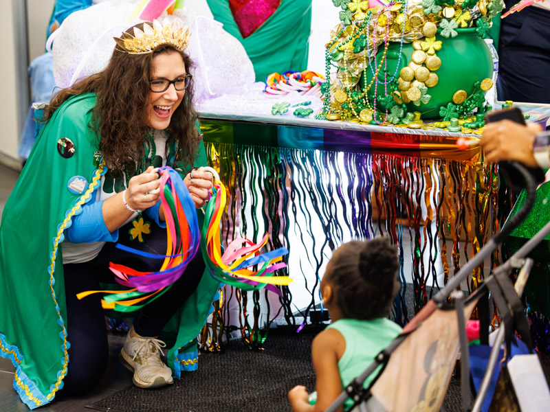 Malla Powell, 4, of Jackson partakes in the fun with her mom Angelica May and Nadia Radowick with Nugget League of Mayhem krewe at the 2026 Petite Parade at the children's hospital. Melanie Thortis/ UMMC Communications