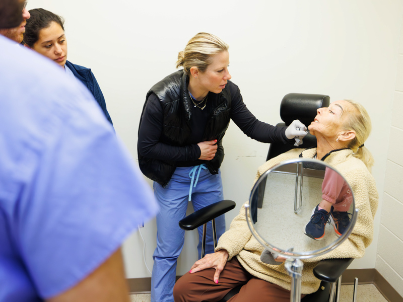 Dr. Laura Humphries, associate professor of plastic surgery, examines Dawn Hoge in a post-op follow-up appointment.