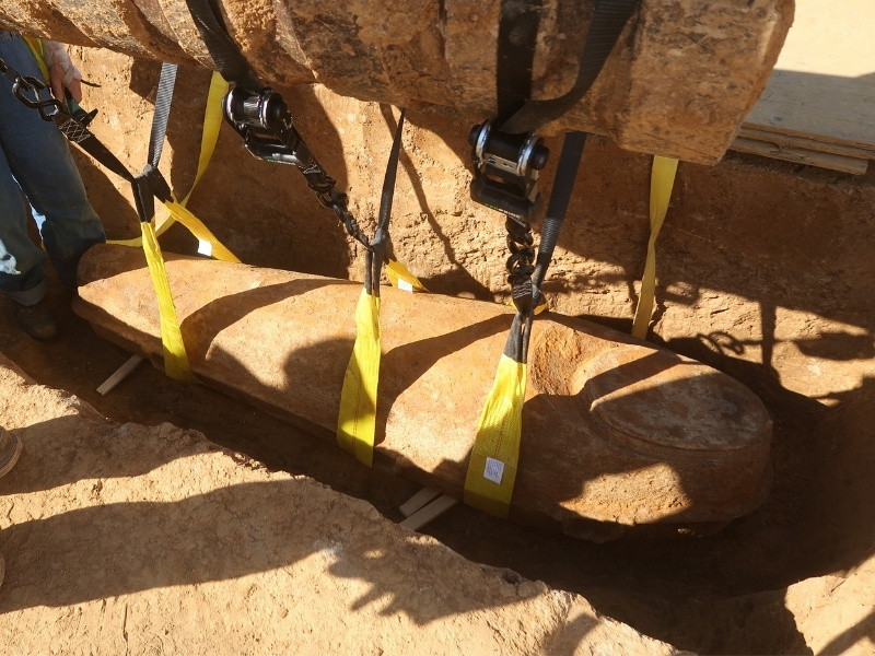 An excavation team of six pull a rare cast iron casket from the grounds of the former Asylum Hill site.