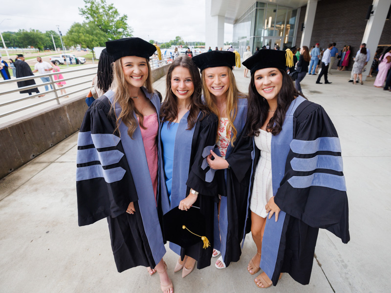 Occupational PhD therapy graduates savor the moment. They are, from left, Kaitlin Senter, Kathleen Tucker, Emily Horn and Ally Gunter.