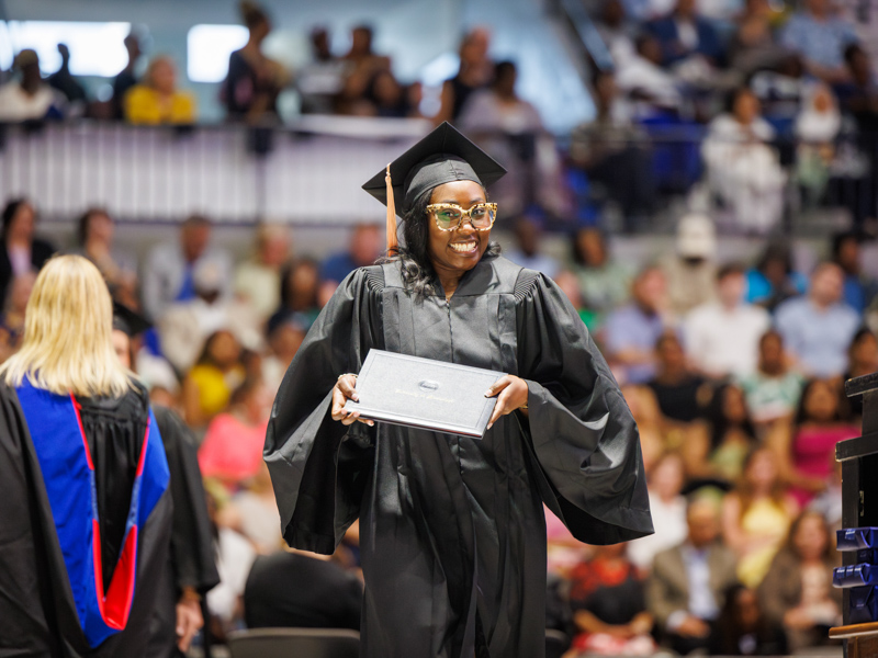 Jessica Jeanea Sledge, a BSN graduate, struts with pride after receiving her diploma.