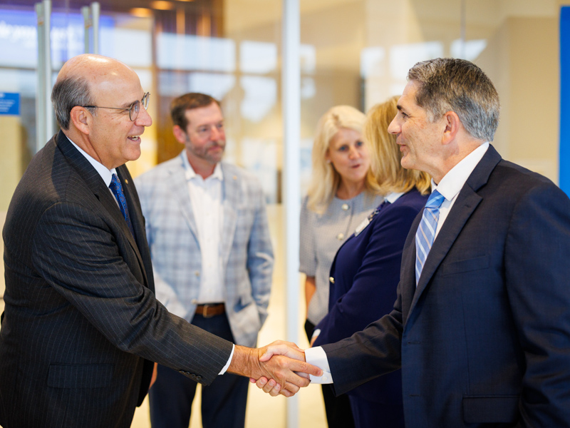 Art Stevens, left, president of retail banking at Trustmark, greets Dr. Rod Rocconi, Ergon Chair for Cancer Research and director of the UMMC Cancer Center and Research Institute.