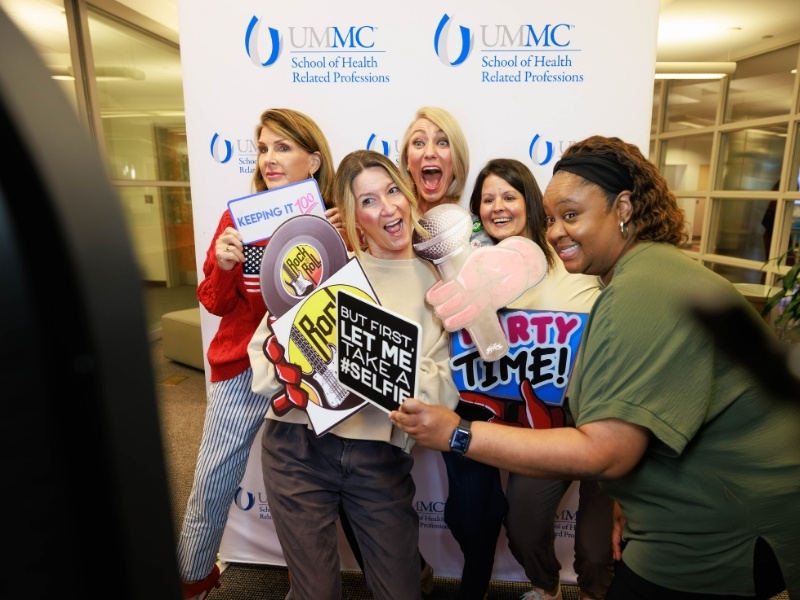 SHRP doctorate of health administration program employees, from left, Elizabeth Franklin, Kimbra Bass, Chair Angela Burrell, Cynthia Senior and Kendria Lyles pose in the photo booth as part of Employee Appreciation Week. Melanie Thortis/ UMMC Communications