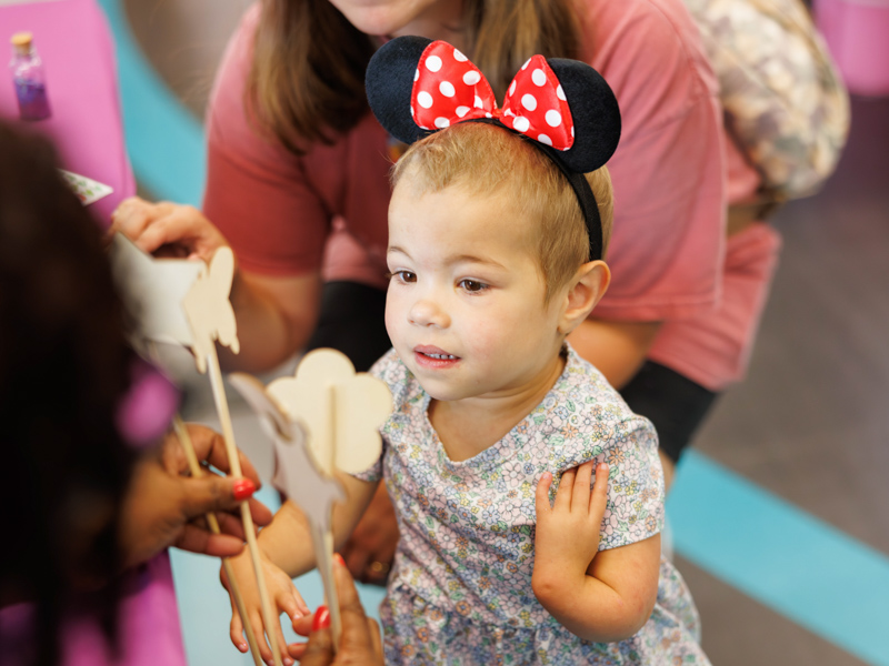 Allyson Ulery, 3, picks out a craft to make at Disney Day hosted in the Sanderson Tower Community Room in the children's hospital.
