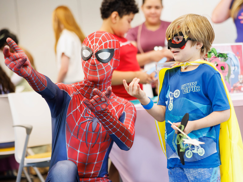 Westen Wilcher,4, of Union practices his web launching skills with Spiderman at Disney Day hosted in the Sanderson Tower Community Room.