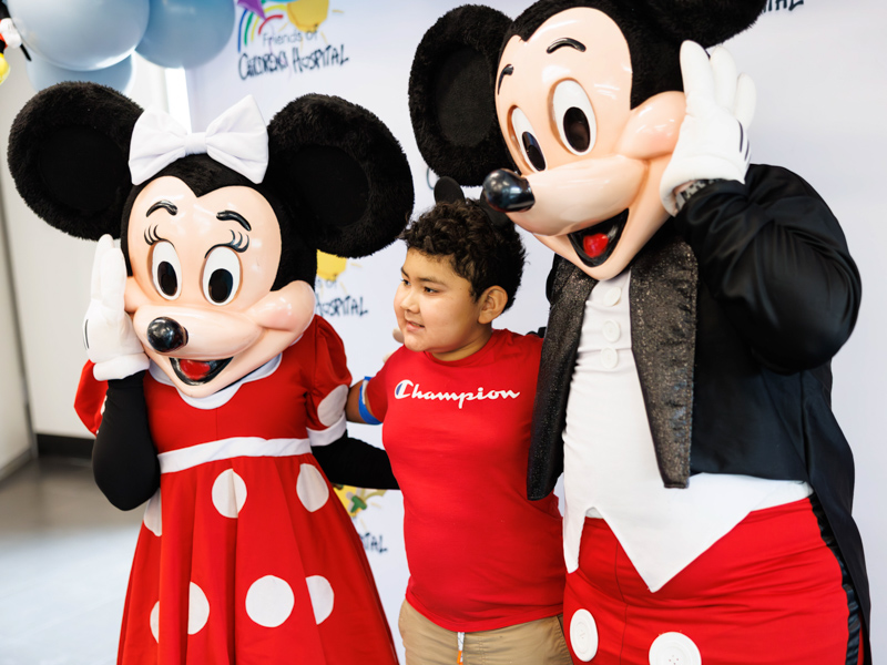 Caleb Cruz, 9, of Ridgeland poses with Minnie and Mickey Mouse at Disney Day hosted in the Sanderson Tower Community Room at the children's hospital.