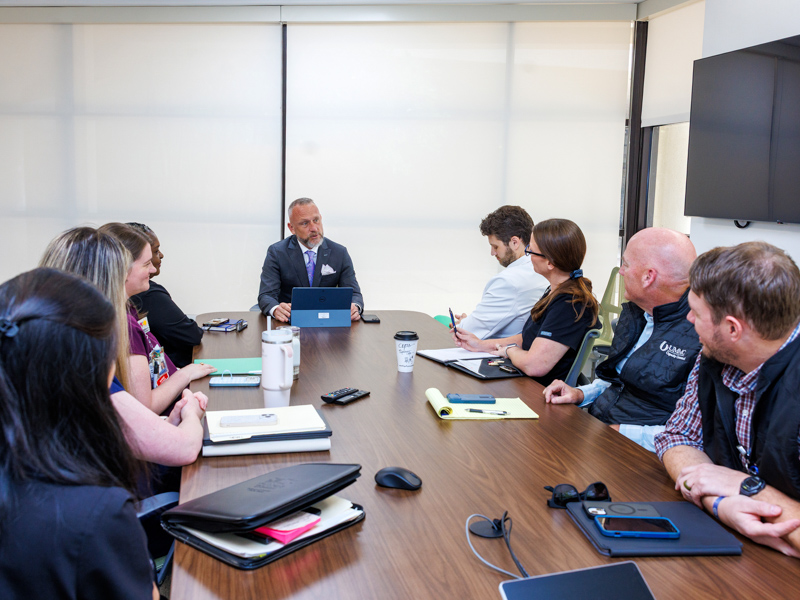 Smith leads a team meeting with various nursing leaders at the children's hospital.