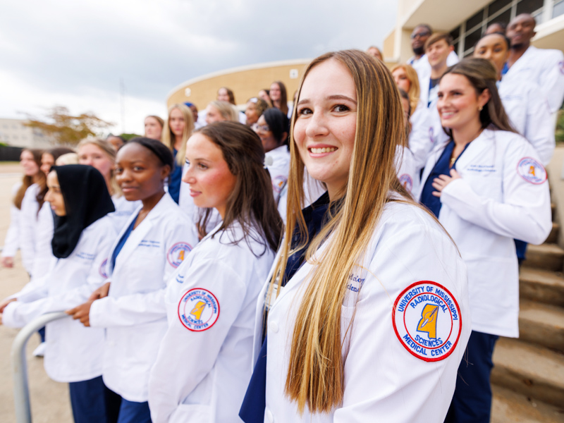 Radiologic Sciences program student Campbell McCoy prepares for a group photo during orientation week. Jay Ferchaud/ UMMC Communications