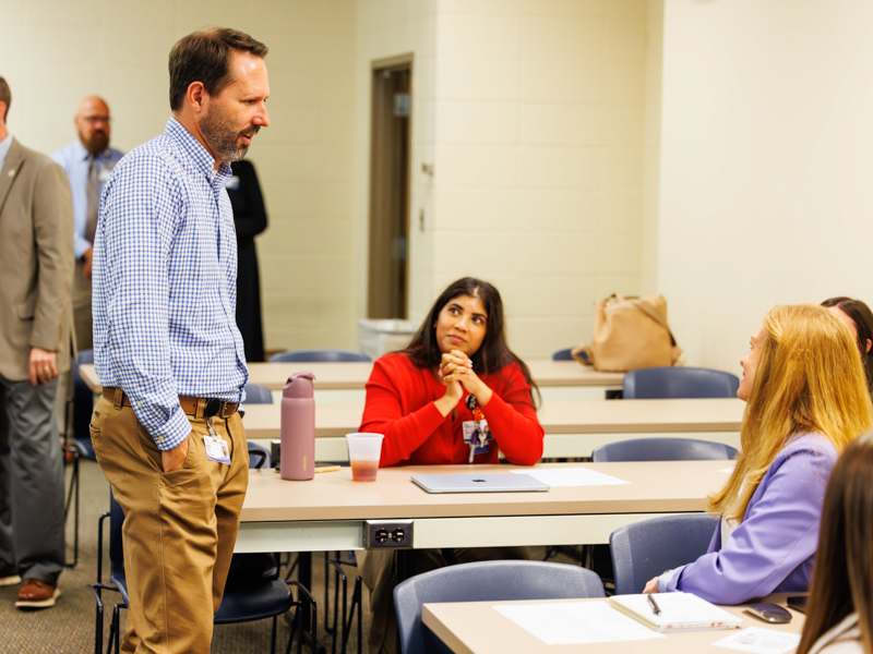 Joya Johnson, seated, listens during a chat with fellow students and others during CRNA orientation Aug. 10. In the foreground is Ben Brown, lead CRNA at the Medical Center.