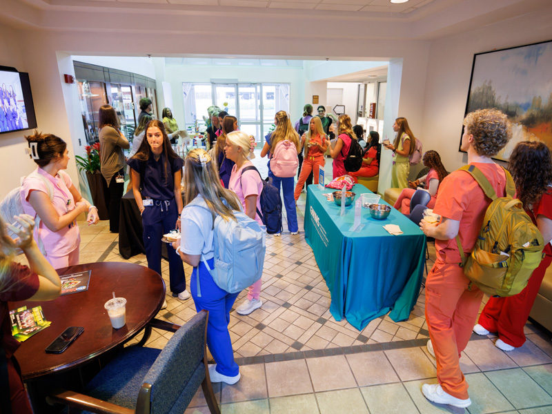 Students crowd the School of Nursing lobby where a breakfast of coffee, pastries and other treats were provided. Joe Ellis/ UMMC Communications