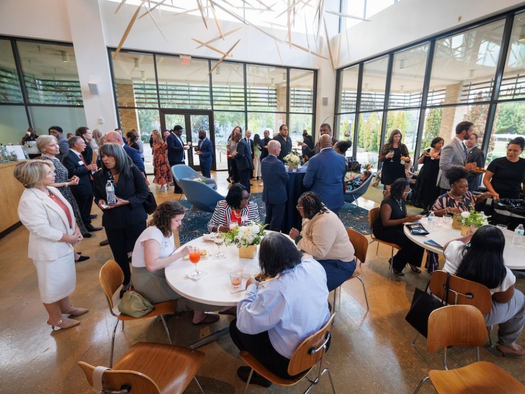 Guests dine and mingle in the hospitality area at the Mississippi Museum of Art ahead of the John D. Bower School of Population Health’s 10th anniversary celebration.