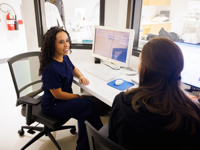 Emilia Calderon, a senior radiologic sciences student, left, speaks with radiologic technologist Clancy Scott during her clinical rotation at UMMC Colony Park North in Ridgeland.