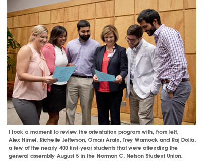 I took a moment to review the orientation program with, from left, Alex Himel, Richelle Jefferson, Omair Arian, Trey Warnock and Raj Dolla, a few of the newarly 400 first-year students that were attending the general assembly Aug. 5 in the Norman C. Nelson Student Union.