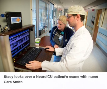 Stacy looks over a NeuroICU patient's scans with nurse Cara Smith