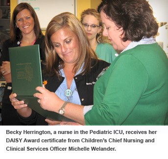 Becky Herrington, PICU nurse, receives her DAISY Award from Chief Nursing and Clinical Services Officer Michelle Welander