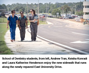 School of Dentistry students walk the new sidewalk.