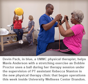Devin Pack, in blue, a UMMC physical therapist, helps Mavis Anderson with a stretching exercise as Bobbie Proctor uses a ball during her therapy session under the supervision of PT assistant Rebecca Stanton in the new physical therapy clinic that began operations this week inside University Wellness Center Brandon.