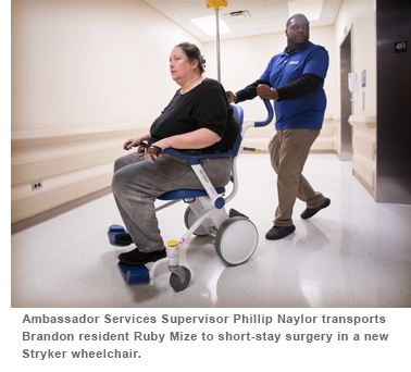 Ambassador Services Supervisor Phillip Naylor transports Brandon resident Ruby Mize to short 4 stay surgery in a new Stryker wheelchair.