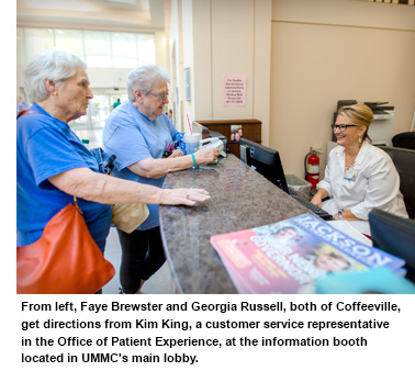 Two elderly ladies receiving information from the UMMC Visitor's Booth 