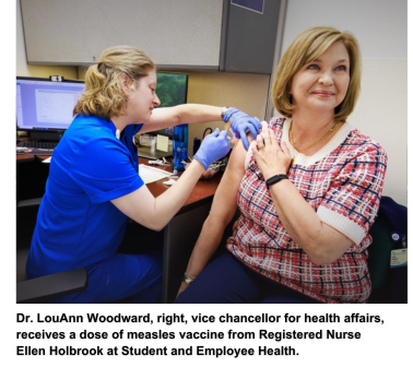 Dr. LouAnn Woodward, right, vice chancellor for health affairs, receives a dose of measles vaccine from Registered Nurse Ellen Holbrook at Student and Employee Health.