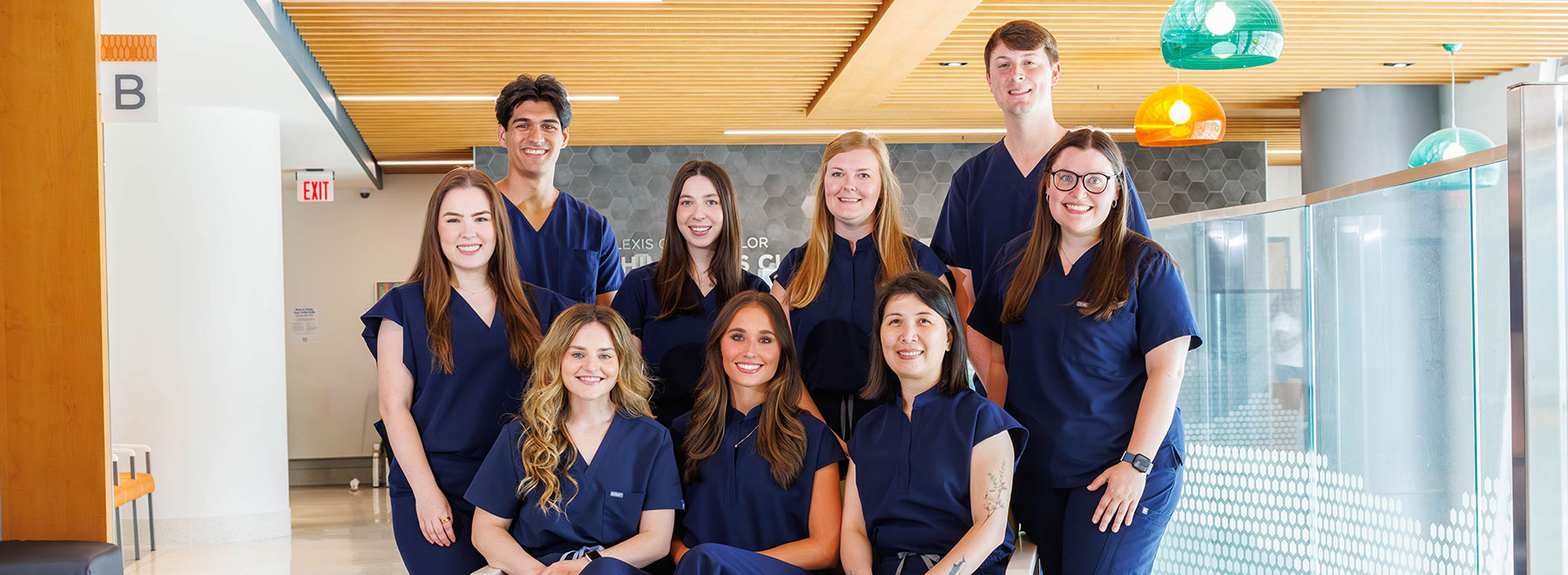 A group of nine UMMC-based pharmacy residents pose in Sanderson Tower.