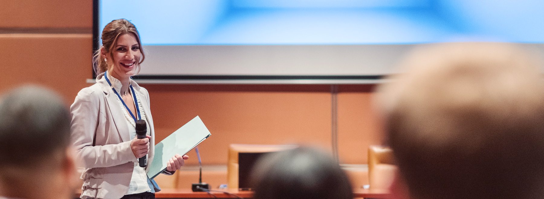 Researcher addressing crowd at symposium
