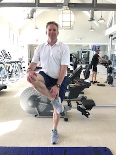 Man performing dynamic figure 4 exercise. 