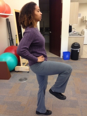 Woman performing marching exercise.