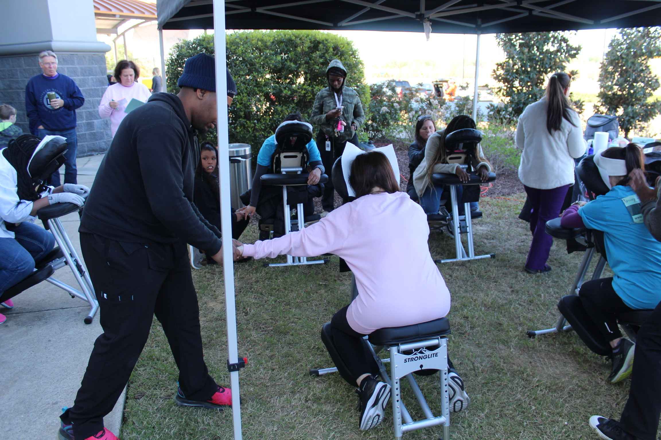 A woman gets her hand massaged in the Massage Tent.