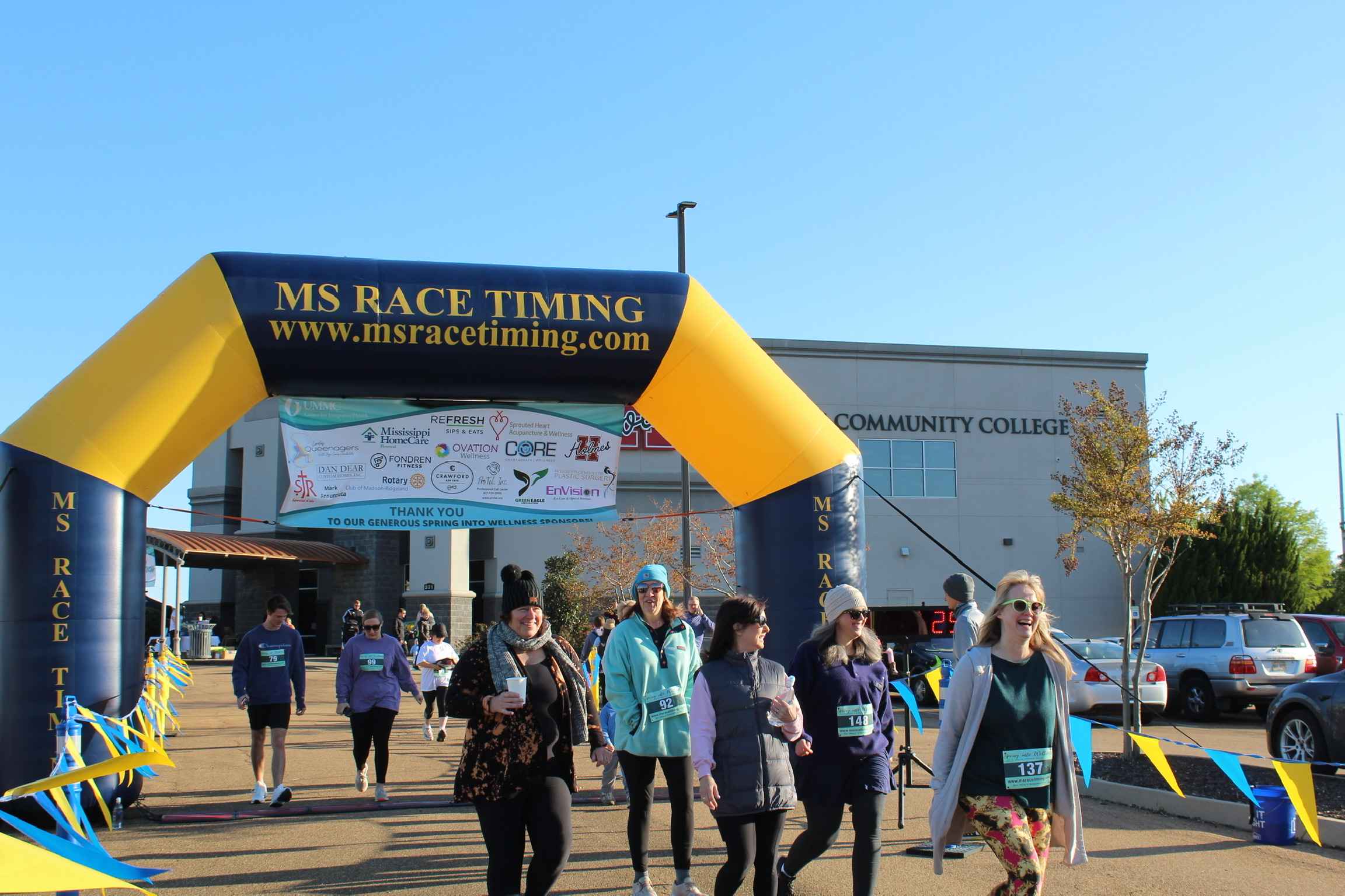 Racers running though the MS Race Timing arch.