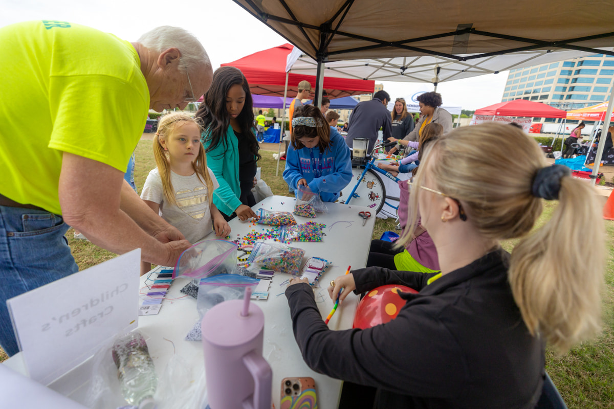 Visitors at the Children's Crafts table.