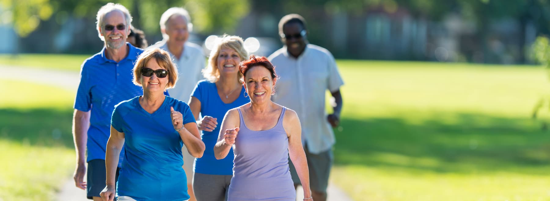 group of people smiling and walking