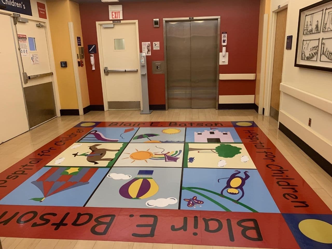 Color art is on the floor near the elevators leading to the inpatient unit.