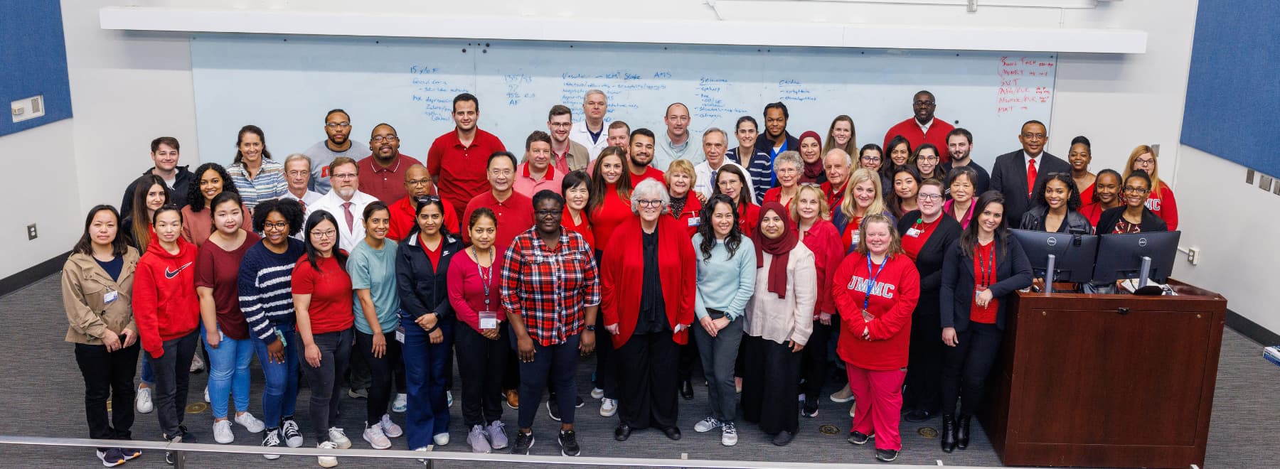 Group photo of Women's Health Research Center staff with many indiviudals dressed in red