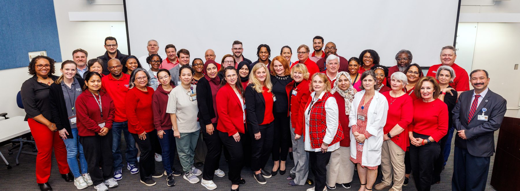 Group photo of Women's Health Research Center staff with many indiviudals dressed in red