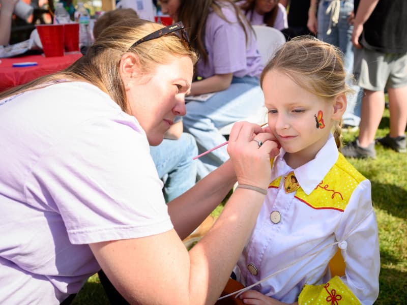 A girl gets her face painted at Family Fun Day 2026.