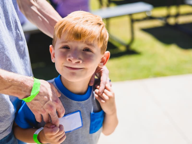 A smiling boy with red hair during Family Fun Day