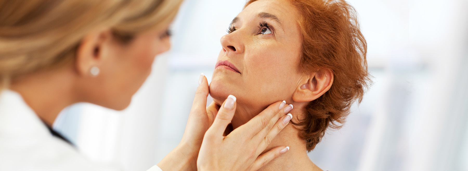 Female provider examines a woman's neck