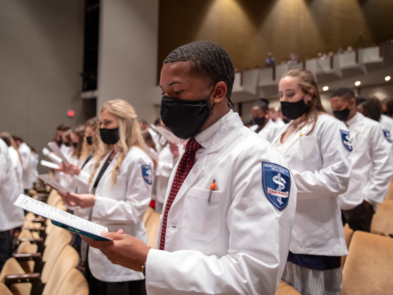 Jacori Daniels, foreground, recites the Oath of Hippocrates with his new medical school classmates.