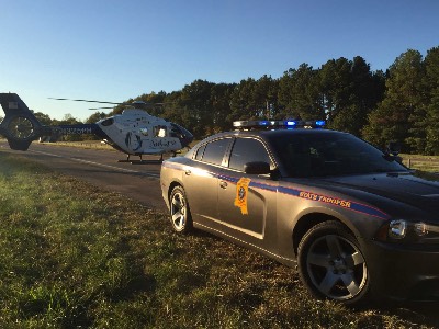 Photo of Mississippi State Highway Patrol vehicle in the foreground and an AirCare helicopter in the bacjground 