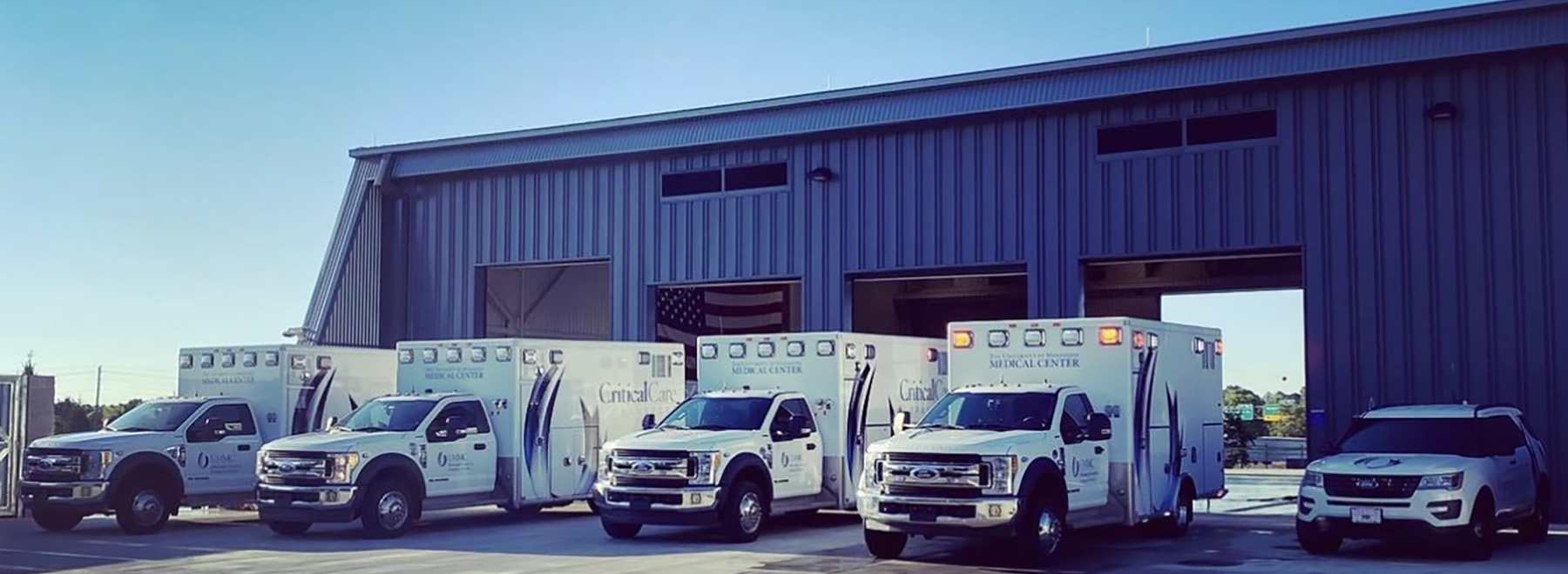 Critical Care Transport fleet parked in front of hangar.