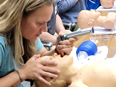 PARTNER Conference participant intubating a dummy patient.