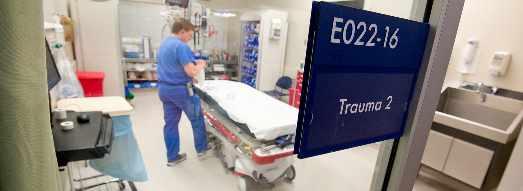 entrance to trauma unit with staff member standing at gurney in background