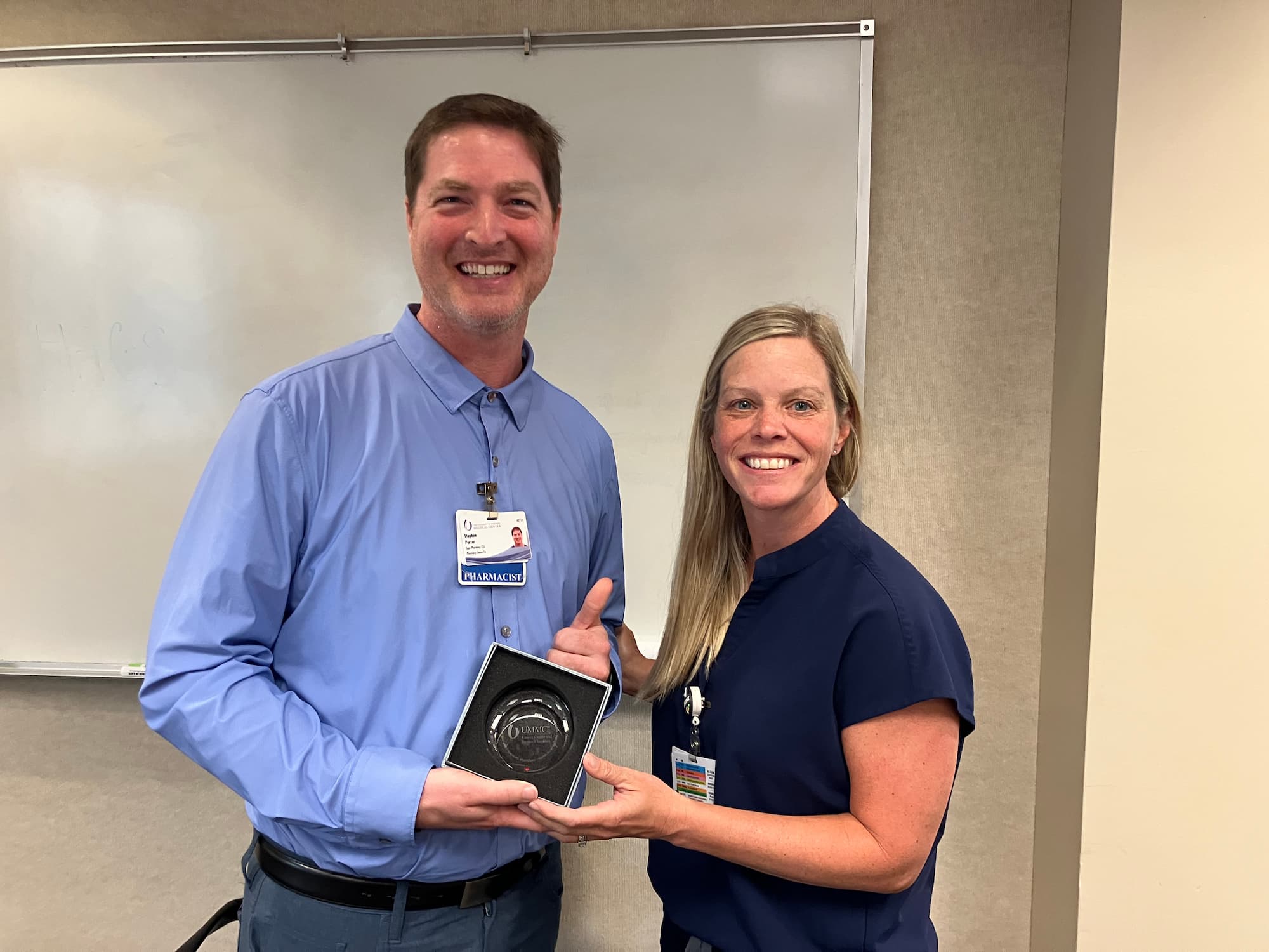 Stephen Porter, pharmacy supervisor at CCRI, is congratulated by Melodie Goodwin, assistant director of pharmacy services at UMMC, on being named CCRI Employee of the Month.