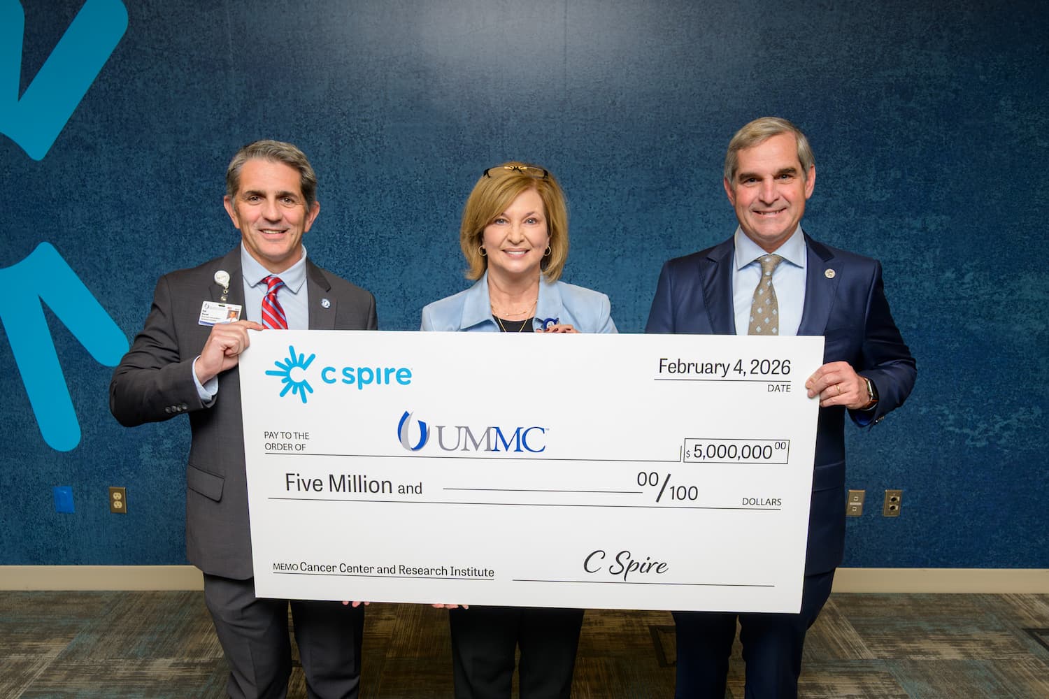 From left, CCRI director Dr. Rod Rocconi, Dr. LouAnn Woodward, vice chancellor for health affairs, and Dr. Holt Crews, assistant professor of obstetrics and gynecology, smile with C Spire's donation to CCRI.